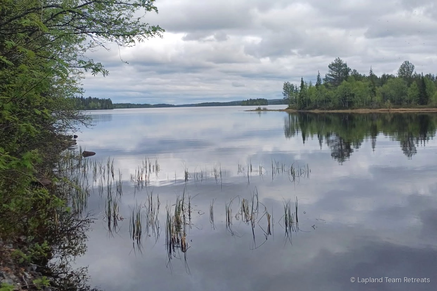 A calm northern lake under the light sky of a Lapland summer night